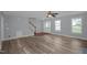 Open-concept living room with modern flooring, neutral walls, staircase and ample natural light at 32 Lattimore Rd, Cameron, NC 28326