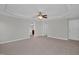 Spacious bedroom with neutral carpet, tray ceiling, ceiling fan, and access to a private bathroom at 32 Lattimore Rd, Cameron, NC 28326