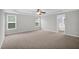 Large main bedroom boasting lots of room, neutral carpet, three windows, and an ensuite bathroom at 32 Lattimore Rd, Cameron, NC 28326