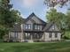 Charming new construction home featuring a stone accent facade, craftsman windows and lovely professional landscaping at 34 Cloudview Ct, Pittsboro, NC 27312