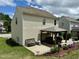 Spacious backyard with a covered patio, outdoor seating, a grill, flowers, and manicured landscaping at 3848 Griffis Glen Dr, Raleigh, NC 27610