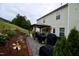 Well-maintained backyard with a patio, a wooden pergola, multiple grills, and flower beds at 3848 Griffis Glen Dr, Raleigh, NC 27610