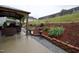 Backyard features a covered patio, landscaped hill, and retaining wall at 3848 Griffis Glen Dr, Raleigh, NC 27610