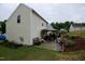 Backyard view shows covered patio, landscaped hillside, and home exterior at 3848 Griffis Glen Dr, Raleigh, NC 27610
