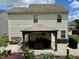 Rear exterior view of the home featuring a covered patio with outdoor furniture, flowers, and attractive landscaping at 3848 Griffis Glen Dr, Raleigh, NC 27610