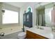 Bathroom featuring a large tub, toilet, vanity, and a window with natural light at 3848 Griffis Glen Dr, Raleigh, NC 27610
