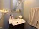 Bathroom featuring a sink, vanity with framed mirror, and decorative towel with monogram at 3848 Griffis Glen Dr, Raleigh, NC 27610