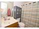 Bathroom boasts a wooden sink vanity, toilet, and cabinet for storage at 3848 Griffis Glen Dr, Raleigh, NC 27610