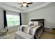 Comfortable bedroom with a ceiling fan, a large window and a queen sized bed at 3848 Griffis Glen Dr, Raleigh, NC 27610