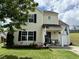 Beautiful two-story home with vinyl siding, neat landscaping, flowering plants, and manicured lawn at 3848 Griffis Glen Dr, Raleigh, NC 27610