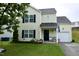 Charming two-story home with a well-manicured front yard, attached garage, and welcoming entrance, perfect for families at 3848 Griffis Glen Dr, Raleigh, NC 27610
