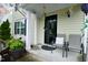 Covered front porch with chairs and decorative plants, leading to a welcoming entrance at 3848 Griffis Glen Dr, Raleigh, NC 27610
