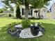 A view of the well-manicured front yard and the home's facade, accented by a decorative tree ring at 3848 Griffis Glen Dr, Raleigh, NC 27610