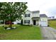Well-manicured front lawn of home with driveway and a red off-road vehicle in the background at 3848 Griffis Glen Dr, Raleigh, NC 27610