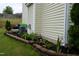 Beautifully landscaped yard with vibrant flower beds, accent lighting, and a stone border, enhancing the property's appeal at 3848 Griffis Glen Dr, Raleigh, NC 27610