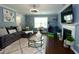 Inviting living room with a large sectional sofa and a decorative fireplace at 3848 Griffis Glen Dr, Raleigh, NC 27610