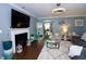 Comfortable living room featuring a fireplace, stylish furnishings, and contemporary design at 3848 Griffis Glen Dr, Raleigh, NC 27610