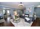 Cozy living room with plush seating, decorative accents, and an open layout at 3848 Griffis Glen Dr, Raleigh, NC 27610