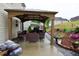 Covered patio includes outdoor furniture and landscaped hill with flowers at 3848 Griffis Glen Dr, Raleigh, NC 27610