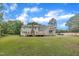 Inviting home featuring a large backyard, complemented by dual wooden decks and a brick chimney at 397 Meadow Rd, Kenly, NC 27542