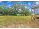 Large backyard featuring green space, gravel area, and lots of trees at 397 Meadow Rd, Kenly, NC 27542