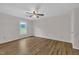 Spacious bedroom with wood floors, ceiling fan, and window views at 397 Meadow Rd, Kenly, NC 27542