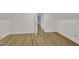 Bedroom with laminate flooring and white trim, with an doorway view of hallway at 397 Meadow Rd, Kenly, NC 27542