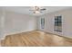 Spacious bedroom featuring hardwood floors, two windows, and a ceiling fan at 397 Meadow Rd, Kenly, NC 27542