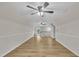 Large bonus room features laminate flooring, trim, and a stairway at 397 Meadow Rd, Kenly, NC 27542