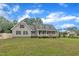 Inviting exterior featuring a covered porch, classic siding, and a well-manicured lawn at 397 Meadow Rd, Kenly, NC 27542