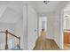 Hallway featuring wood floors, white doors, and access to bathroom at 397 Meadow Rd, Kenly, NC 27542