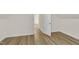 Hallway with laminate flooring and neutral walls leading to another room at 397 Meadow Rd, Kenly, NC 27542