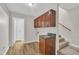 Functional laundry room features overhead cabinets, counter space, and nearby stairs at 397 Meadow Rd, Kenly, NC 27542