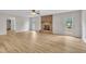 Living room featuring wood floors, a brick fireplace, and exits to outdoor space at 397 Meadow Rd, Kenly, NC 27542