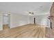 Open living room with wood flooring, white trim, brick fireplace and ceiling fan at 397 Meadow Rd, Kenly, NC 27542