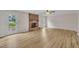 Living room features a brick fireplace, ceiling fan, wood flooring and a doorway to the patio at 397 Meadow Rd, Kenly, NC 27542