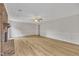Open living room showcasing wood flooring, brick fireplace, and white trim at 397 Meadow Rd, Kenly, NC 27542