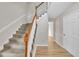 Carpeted staircase with hardwood railing, leading to upper level, and bright entryway at 397 Meadow Rd, Kenly, NC 27542