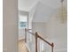 Bright staircase featuring wood floors, white railings, and a chandelier at 397 Meadow Rd, Kenly, NC 27542
