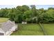 Aerial view of spacious backyard with shed, landscaping, and fenced-in yard at 422 River Ridge Ln, Timberlake, NC 27583