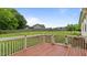 Wooden deck with a white railing offering views of the spacious backyard and fenced-in area at 422 River Ridge Ln, Timberlake, NC 27583