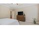 Neutral bedroom featuring an entertainment center, trey ceilings, and a cozy bed setup at 422 River Ridge Ln, Timberlake, NC 27583