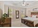 Inviting bedroom with neutral tones, two windows, a ceiling fan, and a comfortable king-sized bed at 422 River Ridge Ln, Timberlake, NC 27583