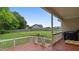 Back deck with wood flooring, white railing, enclosed area for a pet, and a view of the yard at 422 River Ridge Ln, Timberlake, NC 27583