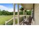 Inviting covered front porch with chairs, hanging plants, and relaxing views of the neighborhood at 422 River Ridge Ln, Timberlake, NC 27583