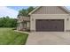 Attached two-car garage with automatic door, convenient access to the house and landscaped yard at 422 River Ridge Ln, Timberlake, NC 27583