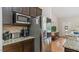 Kitchen with stainless appliances, dark wood cabinets and granite countertops at 422 River Ridge Ln, Timberlake, NC 27583