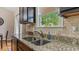 Kitchen sink with stainless fixtures, granite countertops and white ceramic backsplash at 422 River Ridge Ln, Timberlake, NC 27583