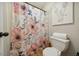 Bathroom featuring a floral shower curtain and an elephant painting above the toilet at 50 Peggy Ct, Raleigh, NC 27603
