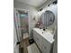 Bright bathroom with a white vanity, round mirror, and white bath mat at 50 Peggy Ct, Raleigh, NC 27603